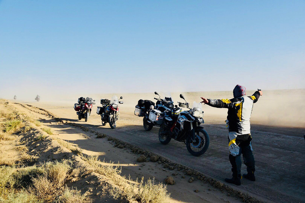 Motorcyclists riding through a remote landscape on an overland journey