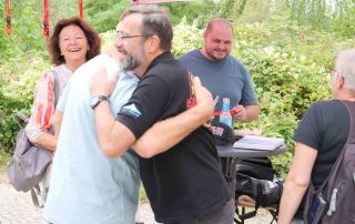 Party participants hugging each other