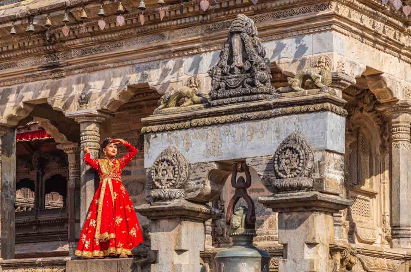 Kathmandu-woman-in-red-dress Shangri La Old wooden Town