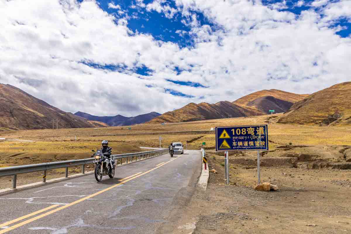 motorcycle tour on the route to mount everest tibet A motorcycle rider crosses the Tibetan Plateau on the scenic route leading toward the Mount Everest region.