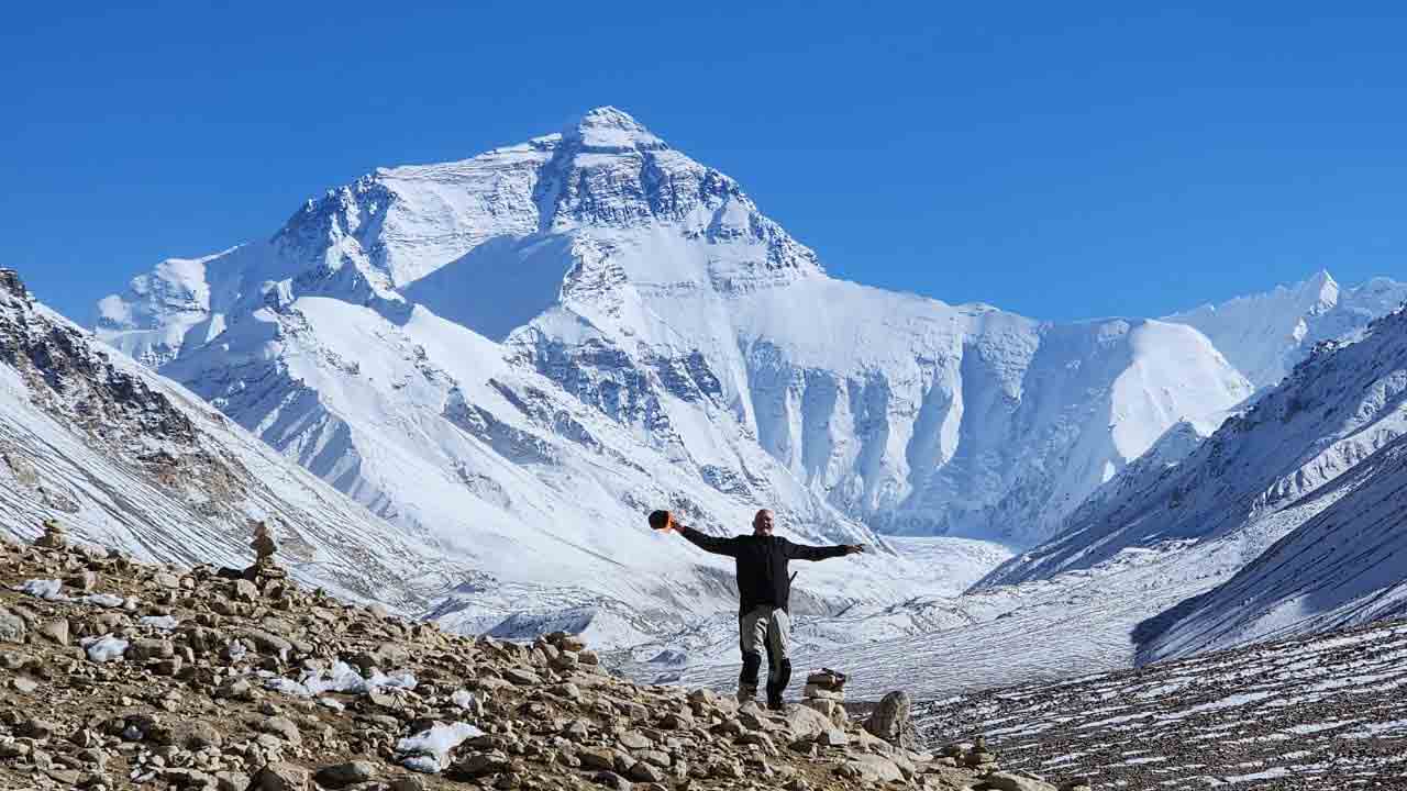 Motorcyclists riding through the Tibetan Plateau on an adventure tour toward Mount Everest Base Camp.