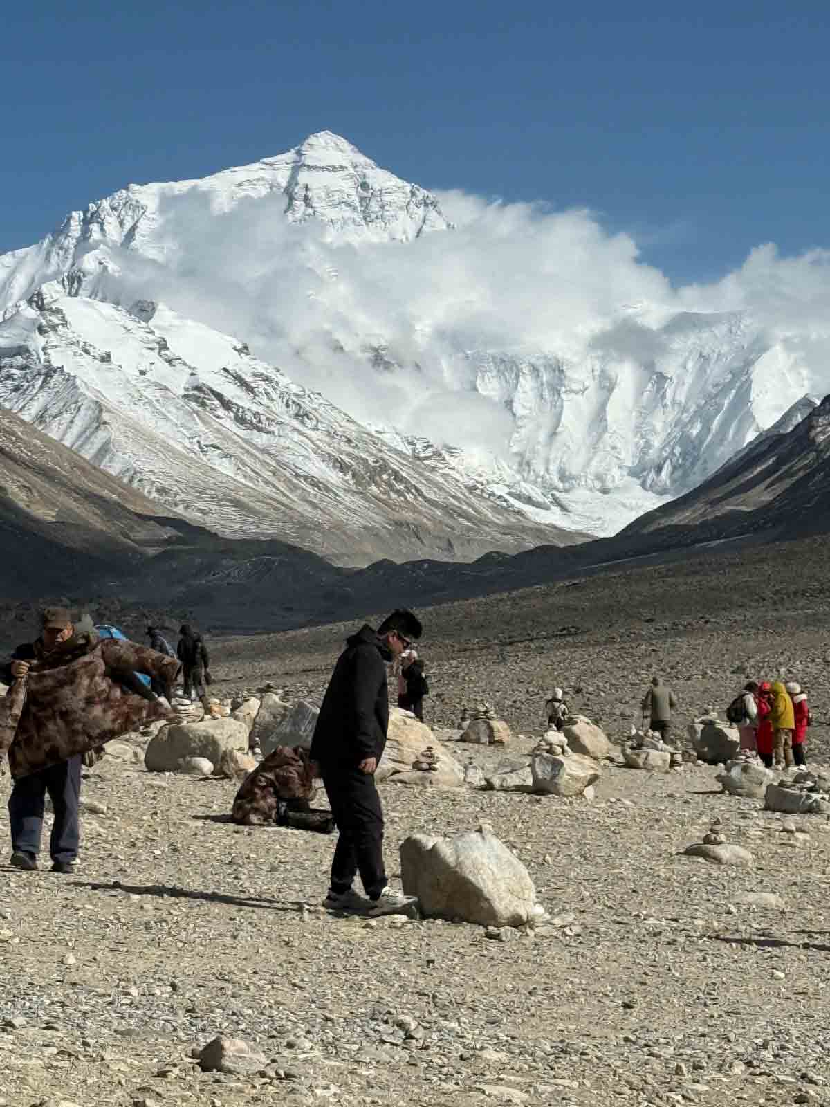 mount everest north face seen from everest base camp tibet Visitors exploring the Everest Base Camp area with a spectacular view of Mount Everest's north face and the Rongbuk Glacier.
