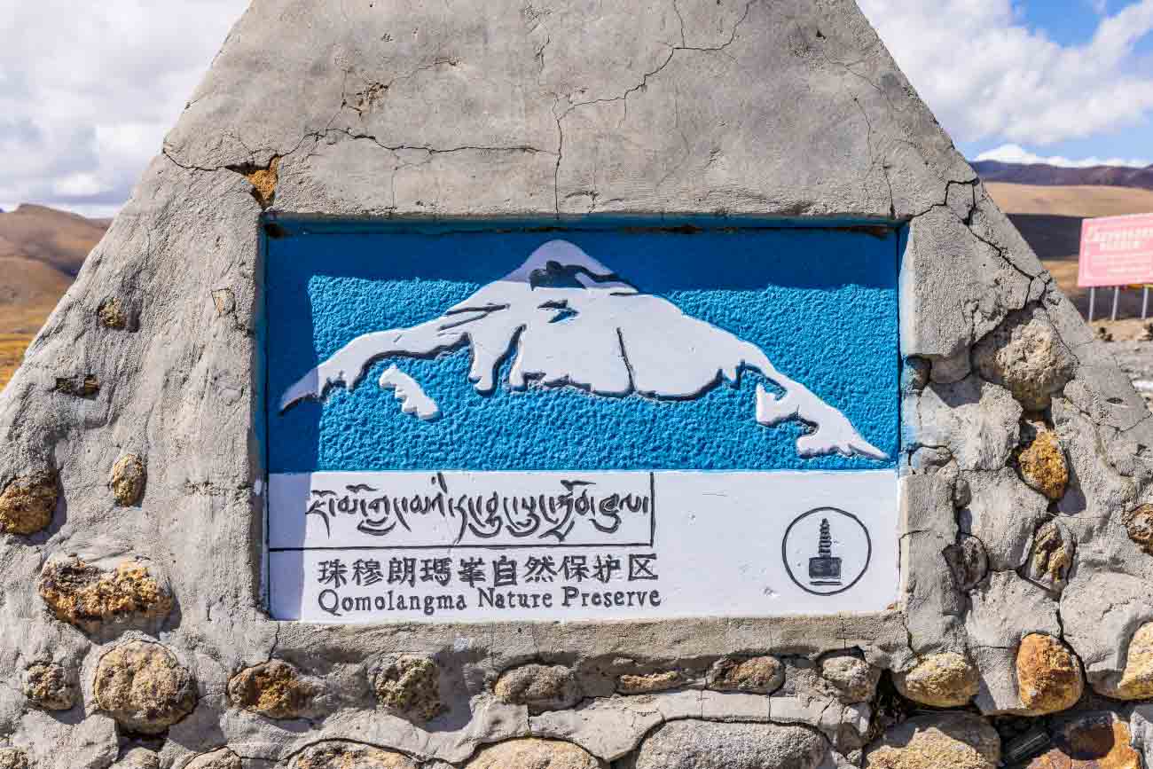 qomolangma nature preserve sign near mount everest tibet Qomolangma Nature Preserve sign welcoming visitors to the protected Mount Everest region on the Tibetan Plateau.