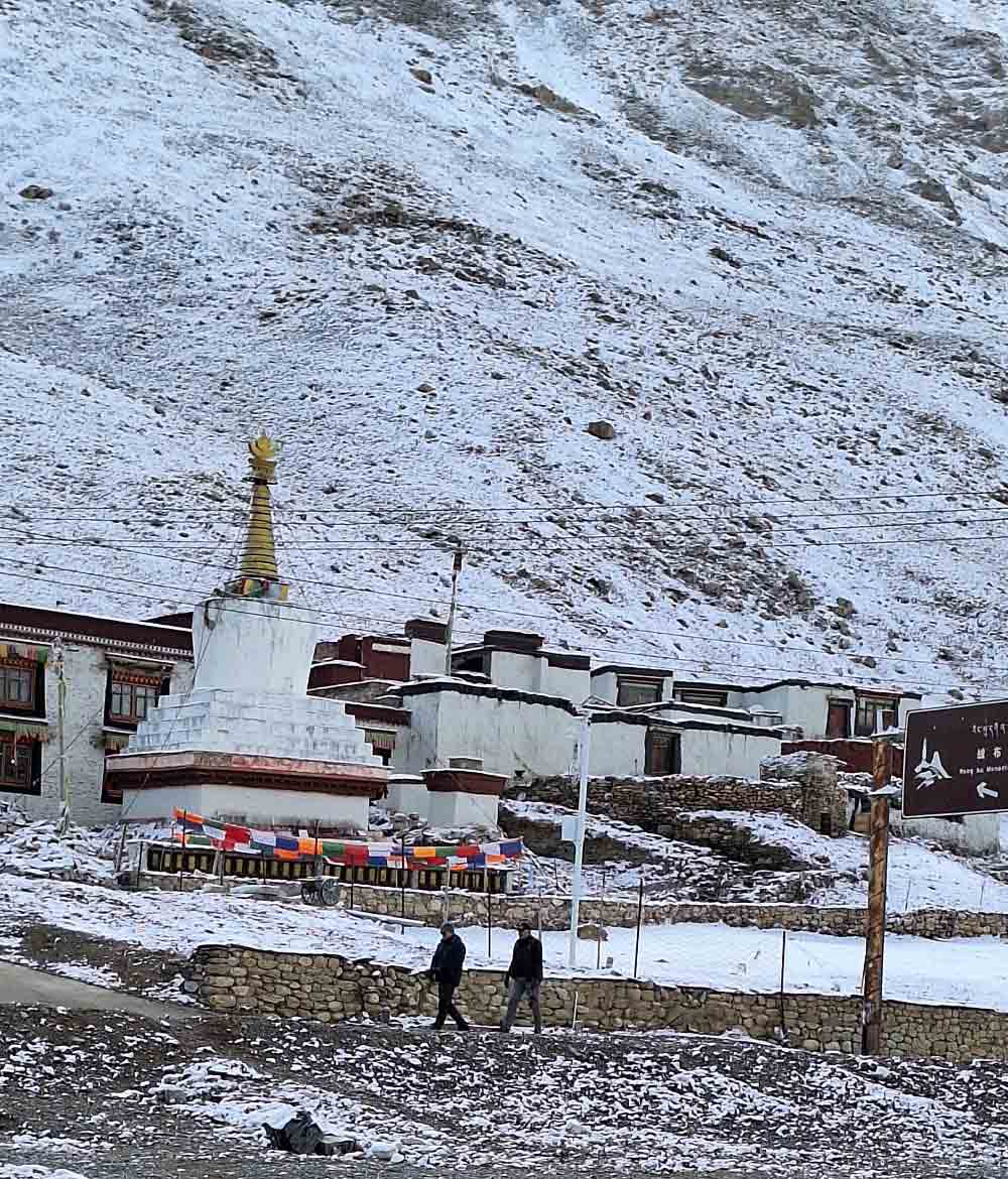 rongbuk monastery with mount everest after snowfall tibet Rongbuk Monastery covered in fresh snow with Mount Everest towering above the Tibetan Plateau in the background.